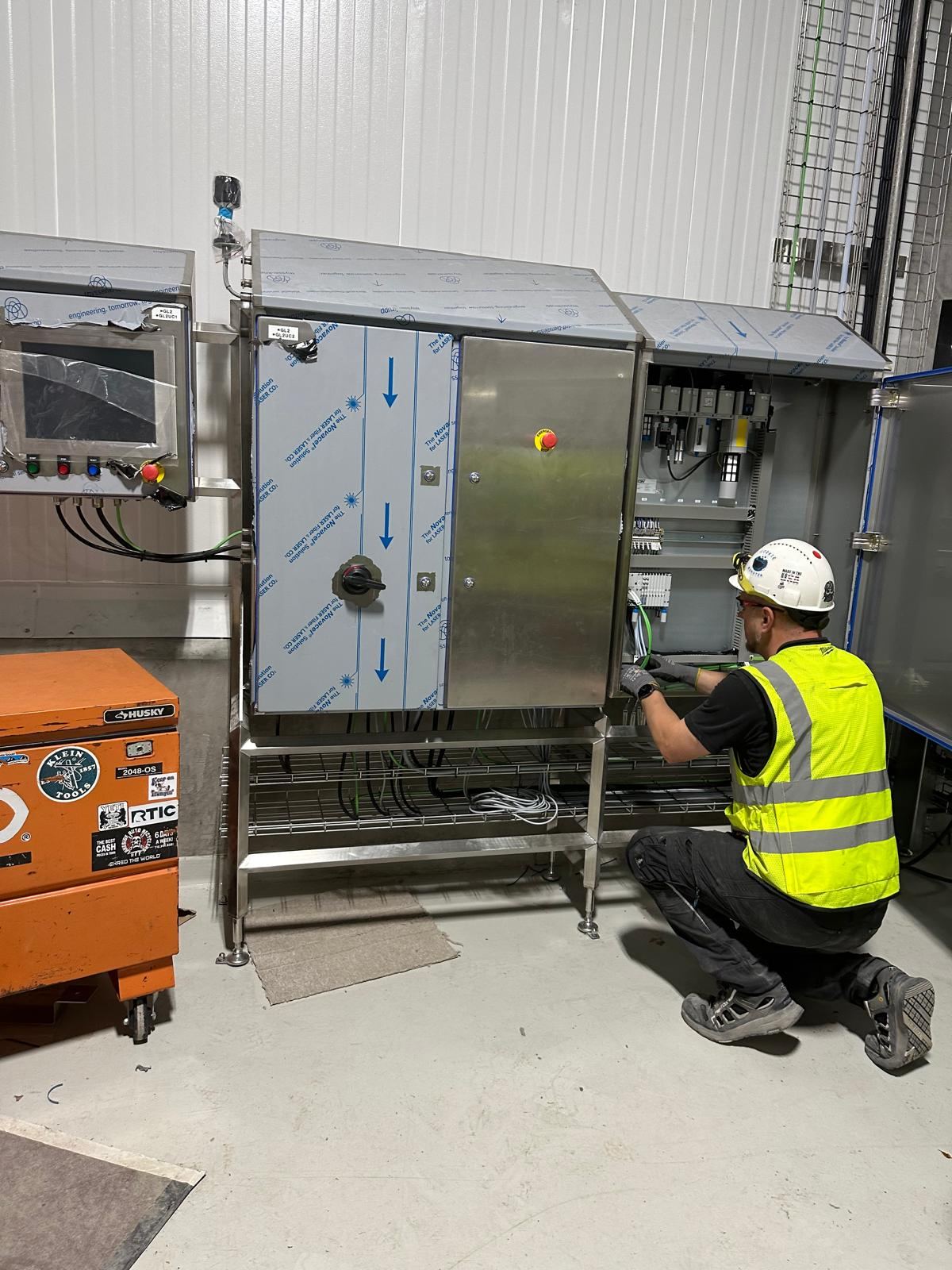 Technician working on a control panel